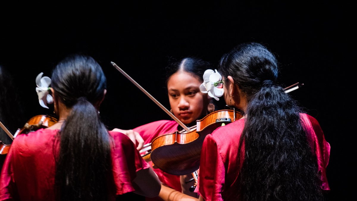 Te Ata: Sinfona for Hope image with three pacific children playing violin. New Zealand Festival of the Arts 2020
