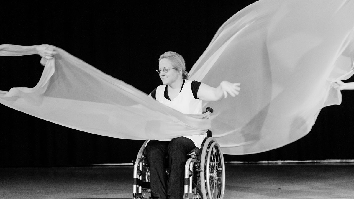 A person dancing in a wheel chair with ribbons flowwing behind: The Art of Observation at the New Zealand Art Festival 2020